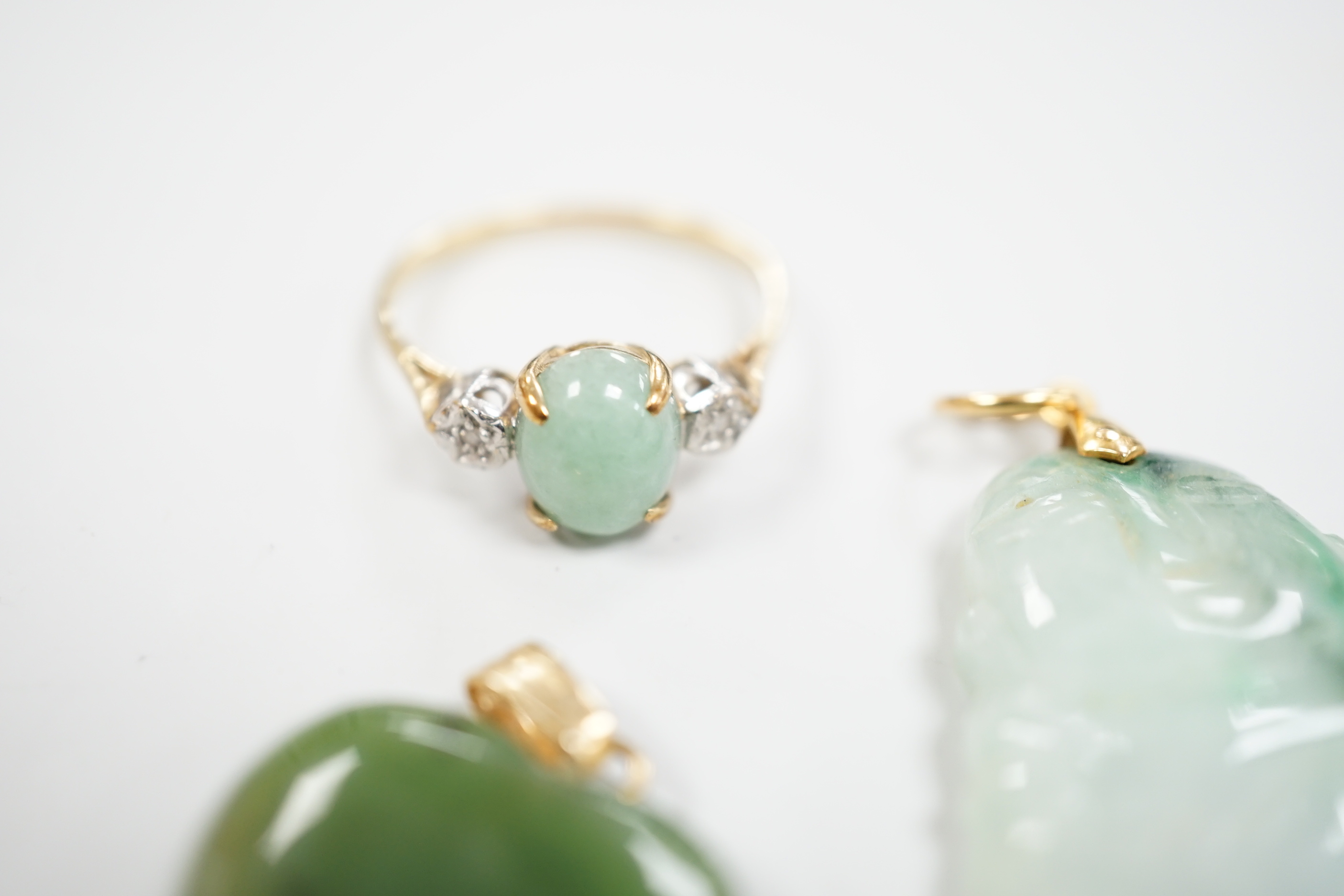 Two mounted jade pendants, including heart shaped nephrite and a 9ct gold, simulated jade and diamond chip set ring.